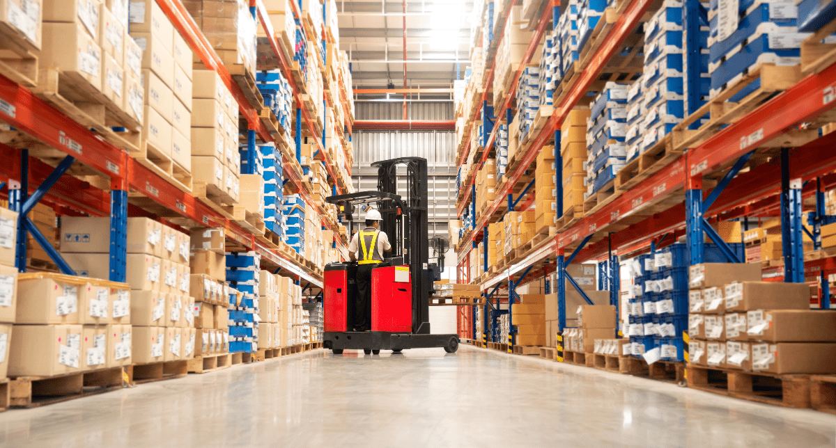 Adherent (formerly Compliance & Risks). worker in warehouse moving packages on forklift - concept for Extended Producer Responsibility for Packaging