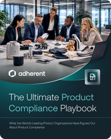 Five professionals in an office examine various products and prototypes on a table. Text overlay reads 'adherent', 'The Ultimate Product Compliance Playbook', and 'What the World's Leading Product Organizations Have Figured Out About Product Compliance'.