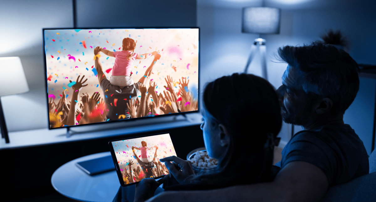 Adherent (formerly Compliance & Risks). Couple watching tv - concept for energy efficiency - Star Rating Table for Colored Televisions