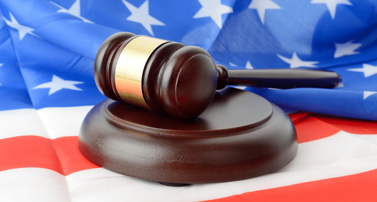 Adherent (formerly Compliance & Risks). Gavel on US flag - concept for Deregulation in the US