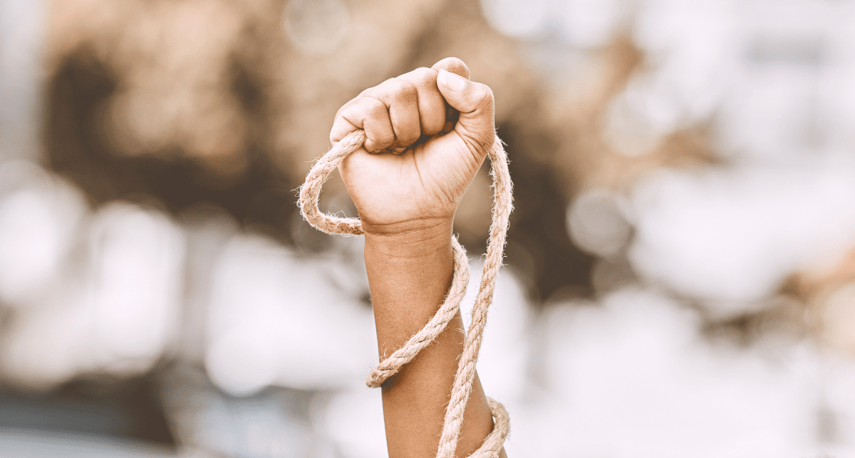 Adherent (formerly Compliance & Risks). Hand holding a rope - concept for forced labor and modern slavery