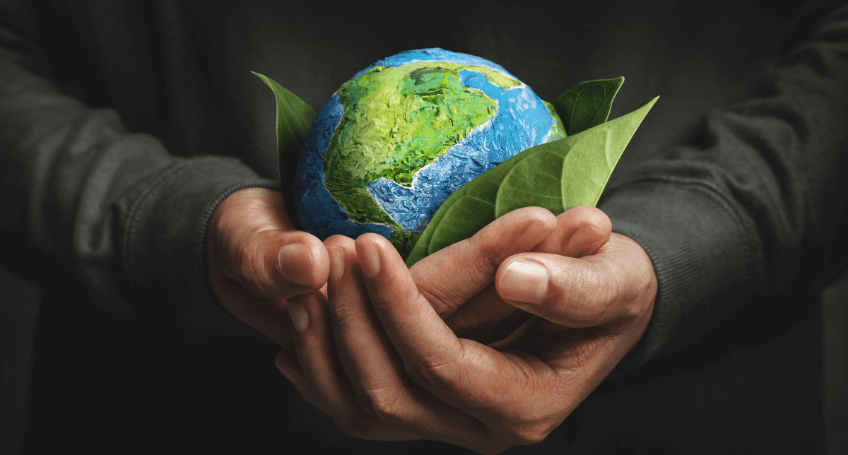 Adherent (formerly Compliance & Risks). Male hands holding a globe - concept for ESG in the US