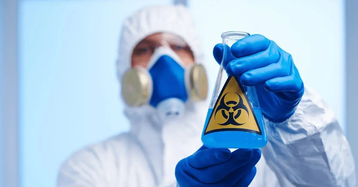 Adherent (formerly Compliance & Risks). Person in hazmat suit and respirator holding a flask with blue liquid and a biohazard symbol.