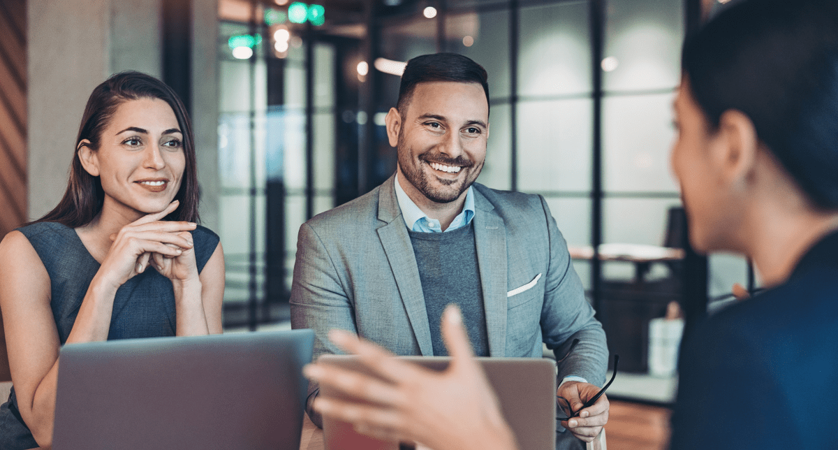 Adherent (formerly Compliance & Risks). Professionals in office setting - discussing compliance trends August 2024
