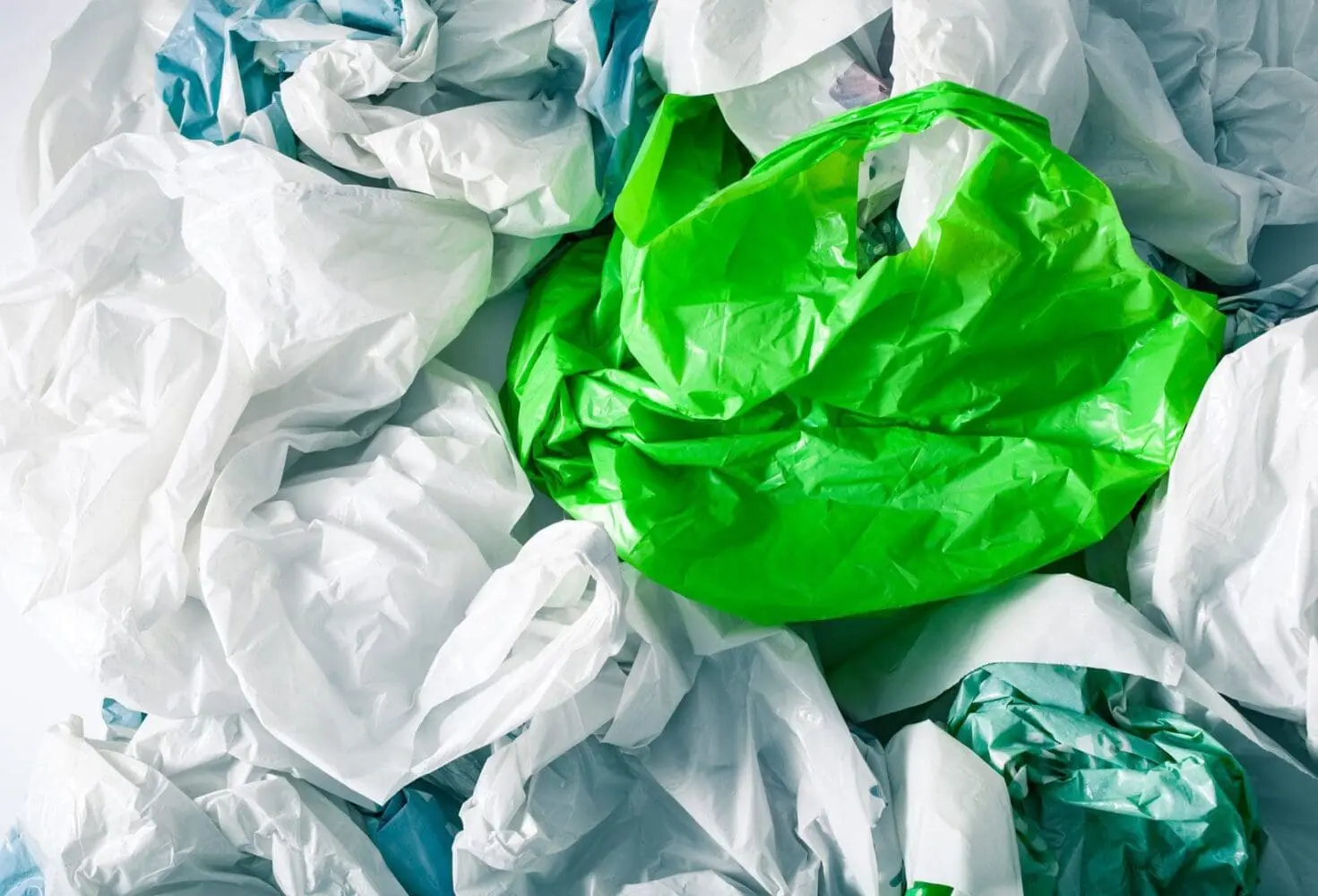 Adherent (formerly Compliance & Risks). A pile of crumpled plastic bags in white, green, and light blue.