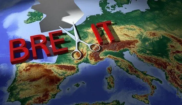 A 3D relief map of Europe with the word 'BREXIT' in large red letters. Scissors are placed between 'BRE' and 'IT', appearing to cut the word.