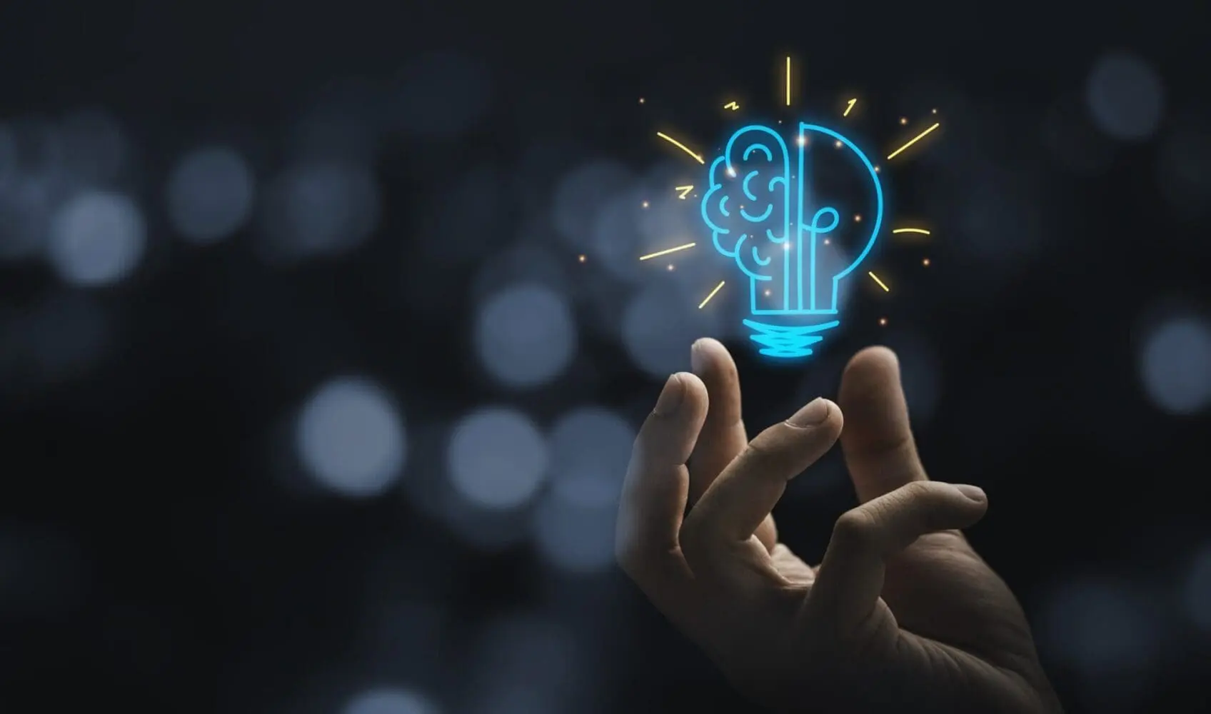 Adherent (formerly Compliance & Risks). A hand holds a glowing blue lightbulb outline, with a brain outline on one side, against a dark, blurred background with bokeh lights.