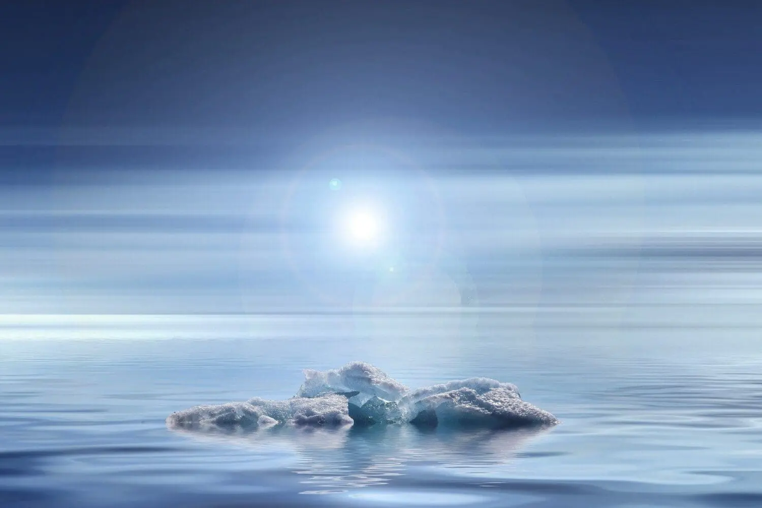 Adherent (formerly Compliance & Risks). A small, jagged iceberg floats on calm blue water under a bright sun with lens flare in a streaked blue sky.