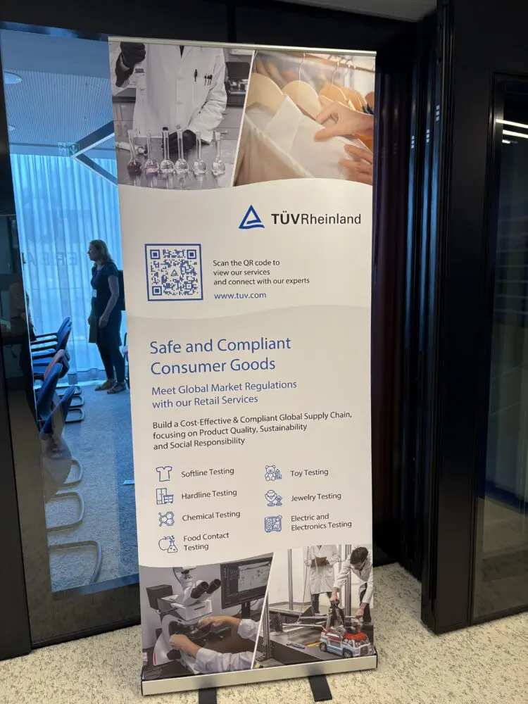 A vertical banner for TÜV Rheinland, detailing consumer goods testing services with text, a QR code, and images of lab work and product testing.
