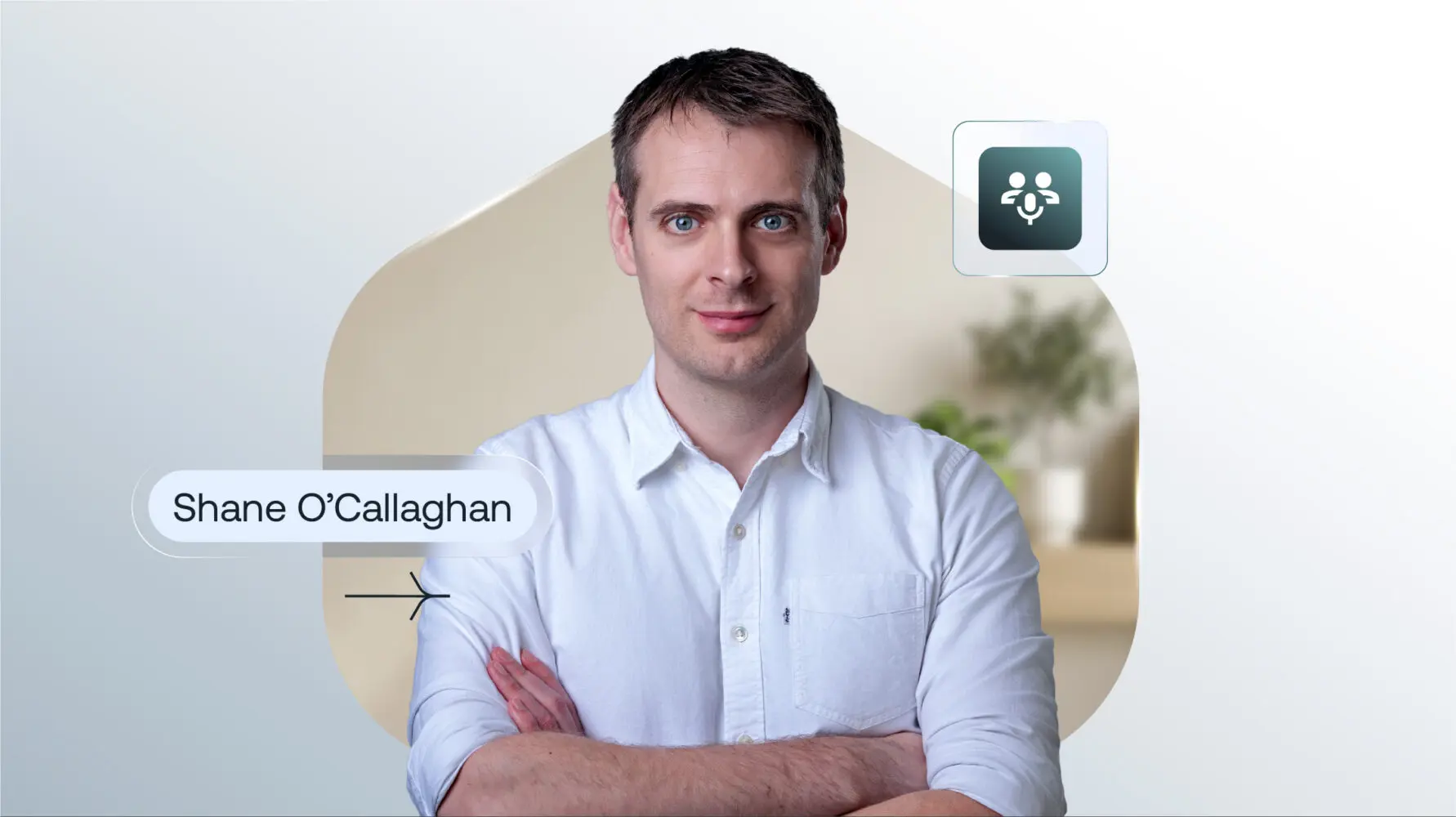 Portrait of Shane O'Callaghan, a man in a white shirt with arms crossed, against a blurred background. His name is displayed on the left, and an icon of two people with a microphone is in the top right.
