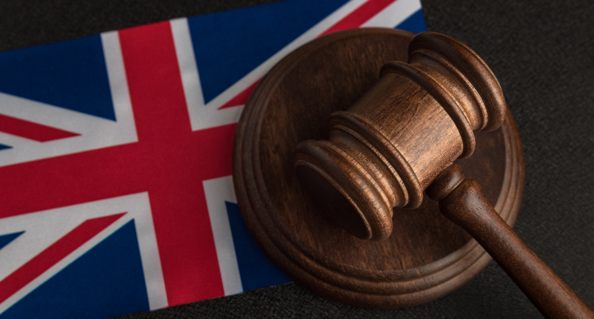 Adherent (formerly Compliance & Risks). A wooden gavel and its sound block resting on a United Kingdom flag.
