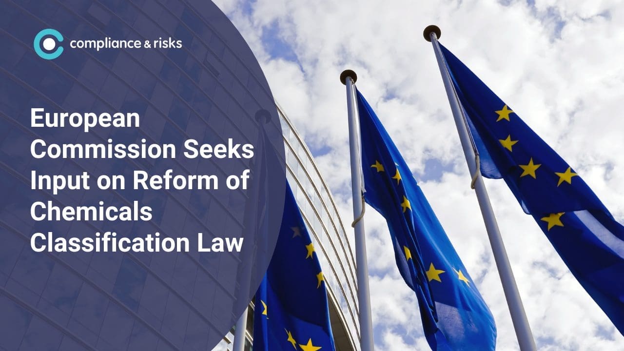 Three EU flags in front of a modern building under a cloudy sky, with text overlay: 'European Commission Seeks Input on Reform of Chemicals Classification Law' and 'compliance & risks' logo.