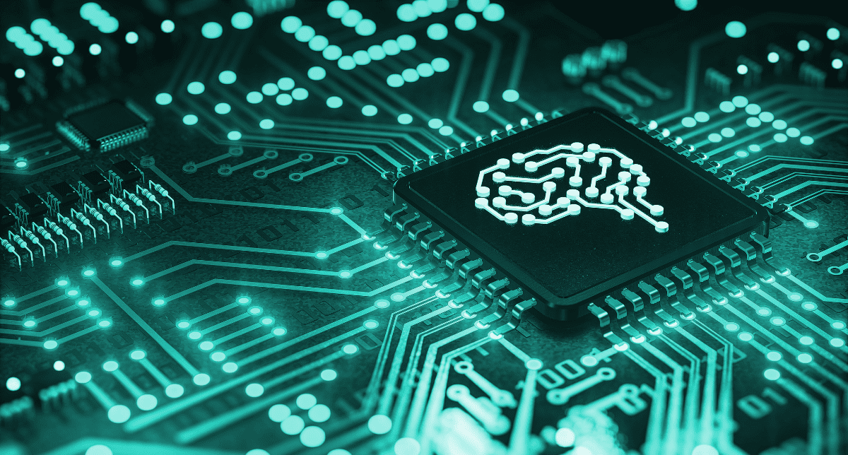 A close-up of a teal-glowing circuit board with a black processor chip featuring a white brain icon.