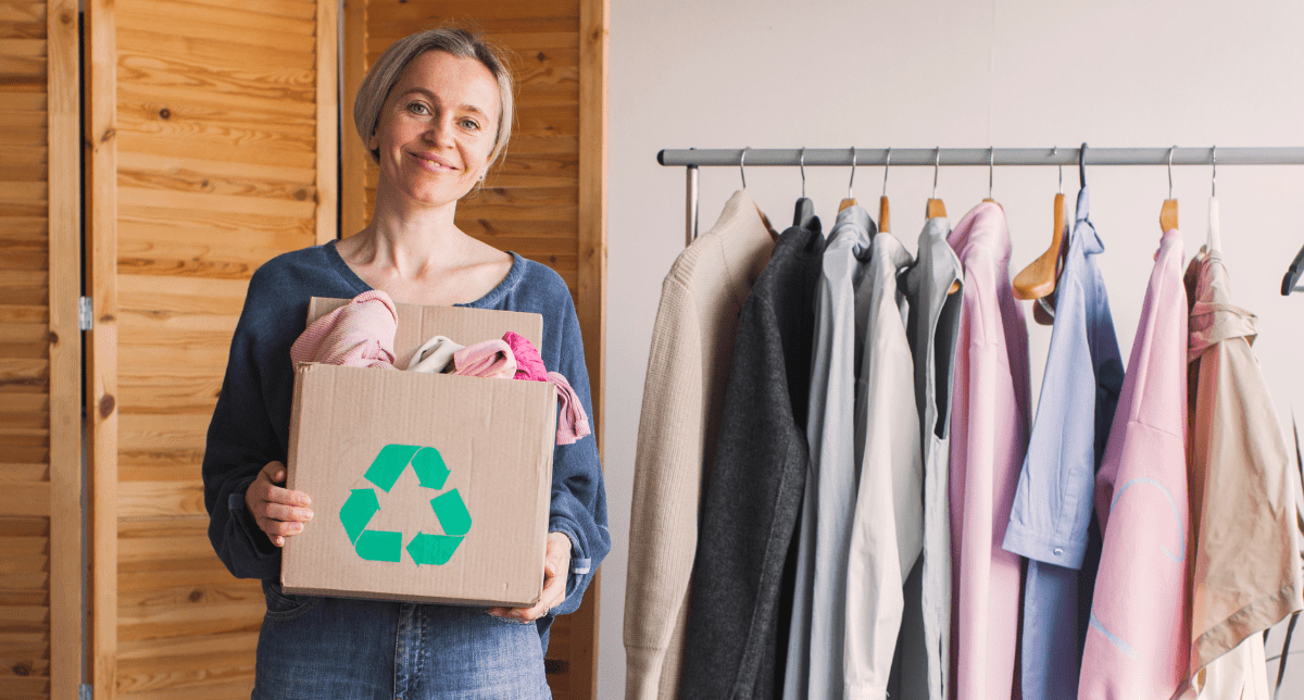 Woman holding recycling box with clothes - concept for Extended Producer Responsibility for textiles