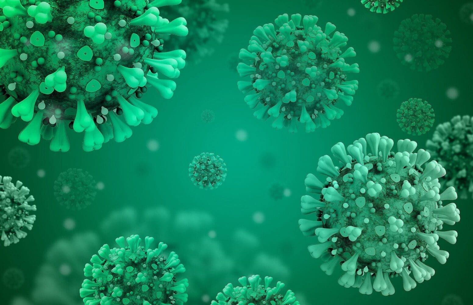 An illustration of multiple green and teal virus particles with spiked surfaces against a gradient green background.