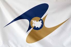 White flag with a blue and gold emblem featuring a central landmass silhouette.