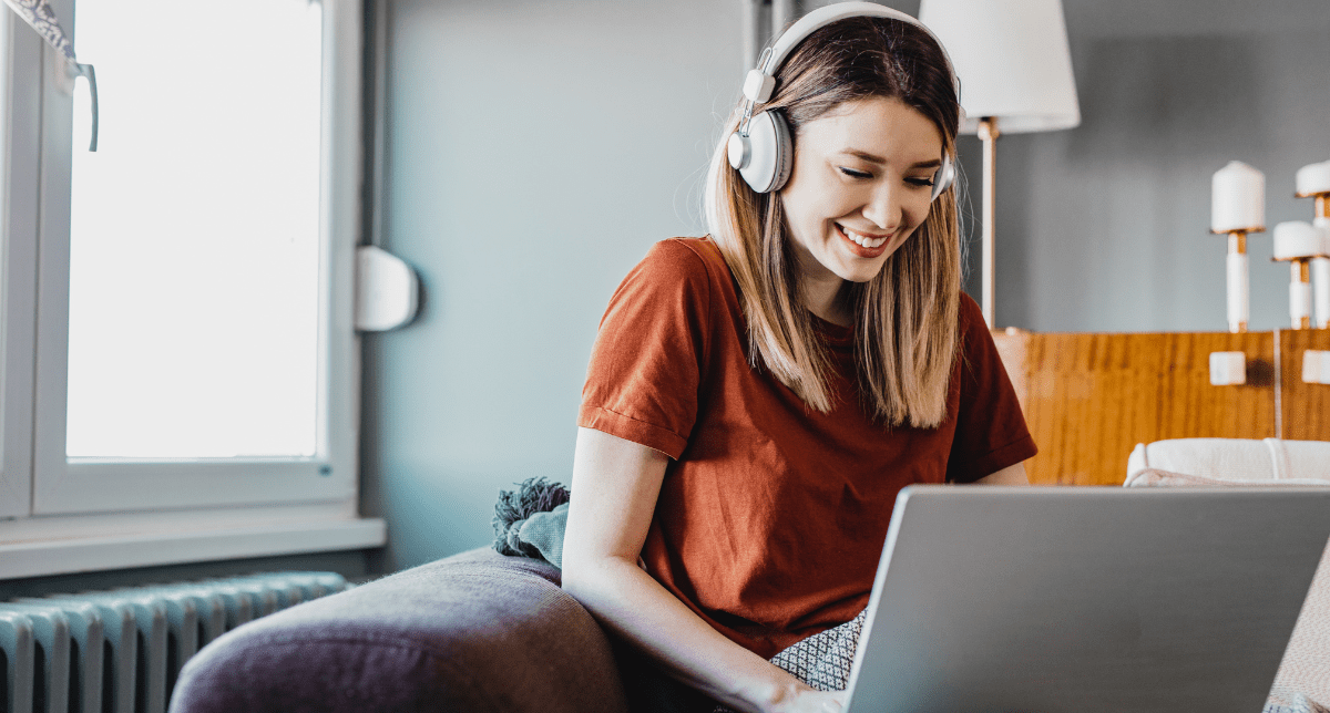 woman wearing headphones using laptop - concept for consumer electronics regulations